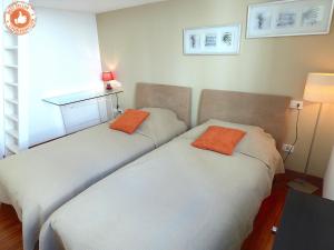 two beds sitting next to each other in a room at ALC - VC2 - 7 min Palais and 3 min Beaches in Cannes