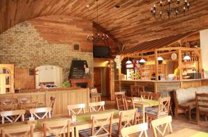 a restaurant with tables and chairs in a room at Penzion Stará sokolovna in Šumperk