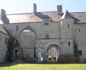a large stone building with a large entrance at MANOIR du QUESNAY in Mandeville-en-Bessin