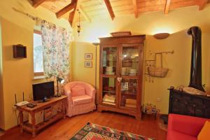 a living room with a tv and a chair at Kitrini Luxury Cottage in Zenempisátika