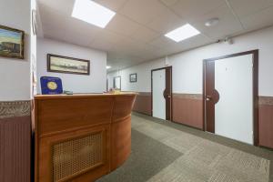 a waiting room with a podium and two doors at Nord House in Saint Petersburg