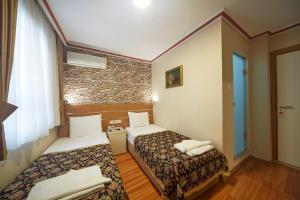 Postel nebo postele na pokoji v ubytování Hotel Akcinar