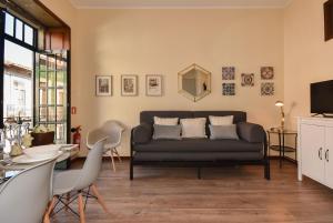a living room with a couch and a table at Azulejos Duplex Apartment - Porto Downtown in Porto