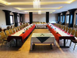 a large conference room with long tables and chairs at Dhulikhel Mountain Resort in Dhulikhel