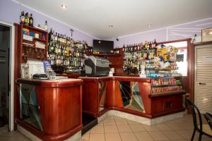 un bar con un montón de botellas de alcohol en Hotel Terranova, en Pisa