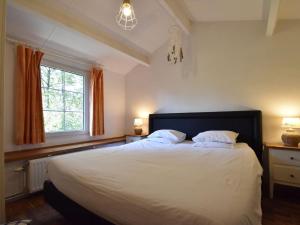 a bedroom with a large white bed with two pillows at Charming gite in Les Avins situated by a stream in Modave