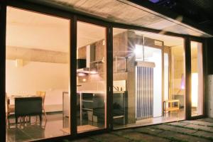 a room with sliding glass doors and a dining room at Centro de Agroecologia y Medio Ambiente de Murcia in Bullas