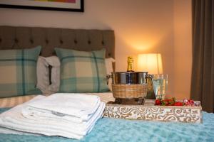 
a bedroom with a bed and a lamp at Abbey Apartments in Barrow in Furness
