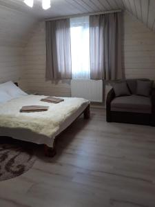 Postel nebo postele na pokoji v ubytování Котедж Зґарда
