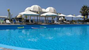a large swimming pool with chairs and umbrellas at Le Terrazze in Agropoli