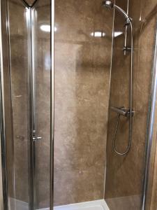 a shower with a glass door in a bathroom at Westerlea Hotel Nairn in Nairn