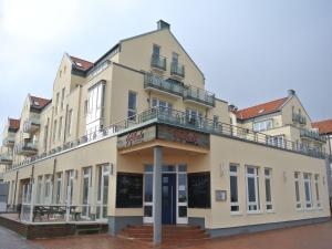 a building with a balcony on top of it at Kaiserhof Apartment 14 in Wangerooge
