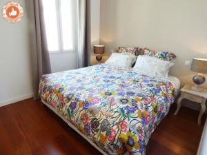 a bedroom with a bed with a colorful comforter at ALC - MA3 - 9 min PAalais in Cannes