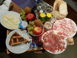 a table topped with plates of food and fruit at Agriturismo Rivet d'Or in Pragelato