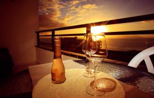 a bottle of wine and a glass on a table at Sunset Paradise in Adeje