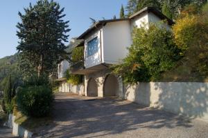 a building with a balcony on the side of a road at casa dei nonni 2 in Tremosine Sul Garda