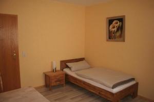 a bedroom with a bed and a picture on the wall at Hotel Michaela in Ramstein-Miesenbach