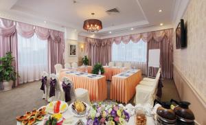 a banquet hall with tables and chairs with food at Ha Long DC Hotel in Ha Long