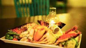a plate of food with vegetables on a table at BeachMirissa Hotel in Mirissa