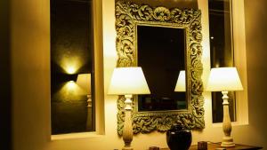 two lamps on a table in front of a mirror at BeachMirissa Hotel in Mirissa