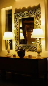 two lamps sitting on a table in front of a mirror at BeachMirissa Hotel in Mirissa
