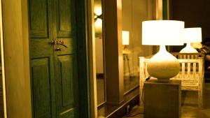 a lamp sitting on a table next to a door at BeachMirissa Hotel in Mirissa
