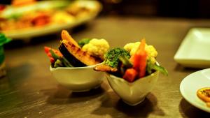 two bowls of vegetables sitting on a table at BeachMirissa Hotel in Mirissa