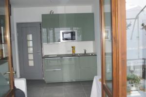 a kitchen with a sink and a microwave at casa dei nonni 2 in Tremosine Sul Garda