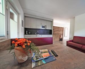 a living room with a couch and a table at Residence Tannhof in Caldaro