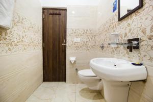 a bathroom with a white toilet and a sink at FabHotel Royal Villa Hussainpura Chowk in Amritsar