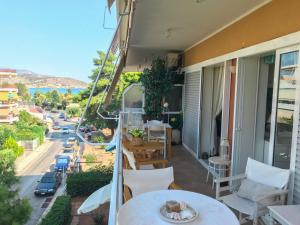 a balcony with a table and a view of a street at Kerry's Cosy Apartment in Vari