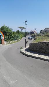 a road with a street light and a stone wall at Casa Vacanze Li Galli in Sant'Agnello
