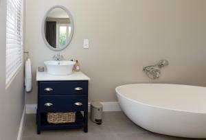 a bathroom with a white tub and a sink at Le Vine Constantia in Cape Town +18 photos