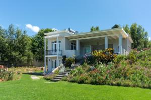 a house with a garden in front of it at Le Vine Constantia in Cape Town