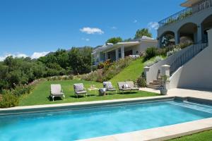 a backyard with a swimming pool and a house at Le Vine Constantia in Cape Town