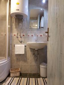 a bathroom with a sink and a toilet at Story Mountain Chalet in Jahorina
