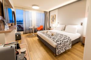 a hotel room with a bed and a table at Mercure Marseille Centre Prado Vélodrome in Marseille +109 photos