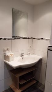 a bathroom with a white sink and a mirror at Am alten Skihang in Wallgau