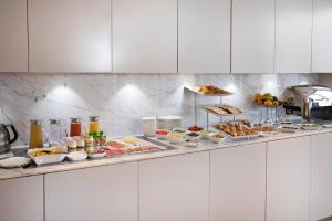 a buffet line with many different types of food at Hôtel R de Paris - Boutique Hotel in Paris