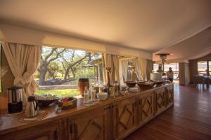 a long counter with food on it in a room at Tau Game Lodge in Madikwe Game Reserve