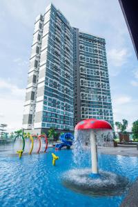 a water park in front of a tall building at MOLEK REGENCY TAMAN MOLEK in Johor Bahru