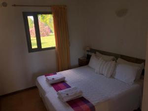 a bedroom with a bed with two towels on it at Tikaykilla Lodge & Wines in Maipú