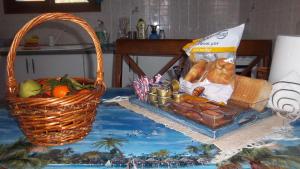 a basket of bread and a basket of fruit on a table at Beautiful Island house with sea view in Spiliazéza