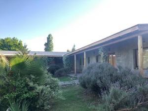 a house with a garden in front of it at Tikaykilla Lodge & Wines in Maipú