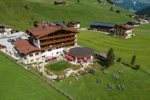 an aerial view of a large building on a green field at Hotel Eden in Tux