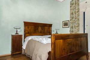 Postel nebo postele na pokoji v ubytování Al Porto Di Lucca B&B