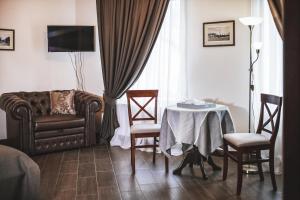 a living room with a table and a couch and a chair at Sicheslav Ekaterinoslav in Dnipro
