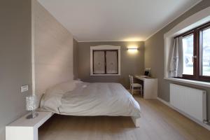 Postel nebo postele na pokoji v ubytování Zoncolan Apartments