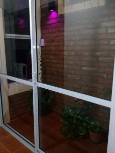 a sliding glass door with a brick wall at La casita de Chany in Mina Clavero