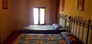 Postel nebo postele na pokoji v ubytování Casa Rural Tío Carlillos
